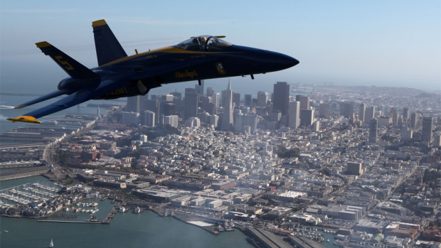 SAN FRANCISCO - OCTOBER 08:  A U.S. Navy Blue Angels F/A-18 Hornet piloted by U.S. Marine Corps Major Nathan Miller flies past the San Francisco skyline during a practice flight ahead of the Fleet Week performance October 8, 2009 in San Francisco, California. San Francisco kicks off its annual Fleet Week celebration October 10 with a parade of ships and an air show featuring the Blue Angels.  (Photo by Justin Sullivan/Getty Images)